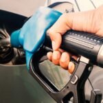 Gasoline being poured into a car from a gas station