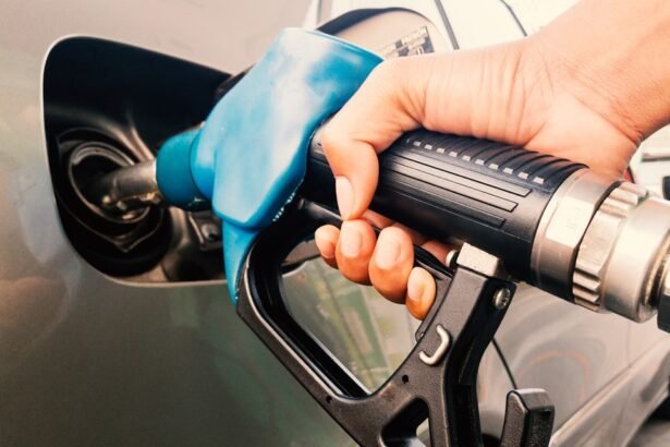 Gasoline being poured into a car from a gas station