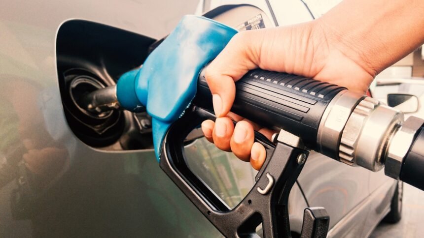 Gasoline being poured into a car from a gas station