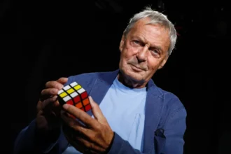 White man holding Rubiks cube