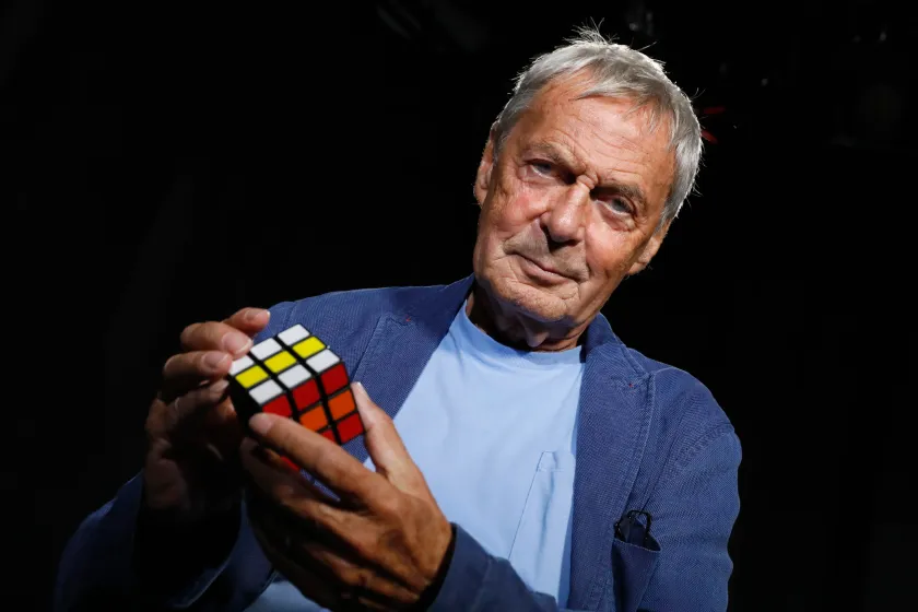 White man holding Rubiks cube