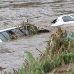 Flooded street with the two cars sinking