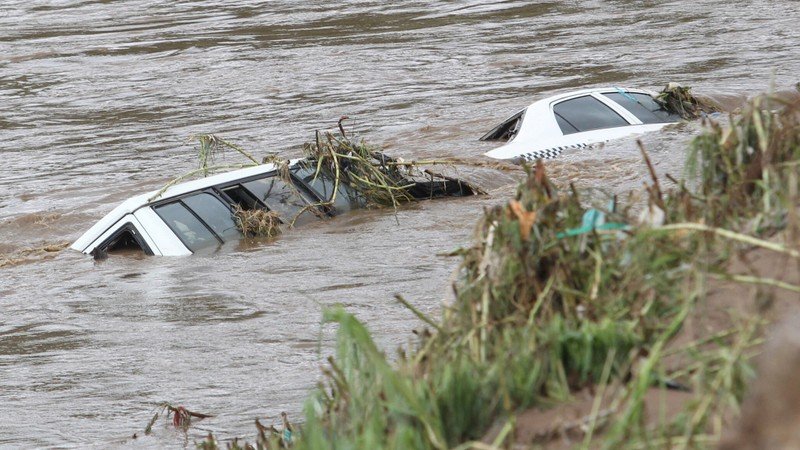 Flooded street with the two cars sinking