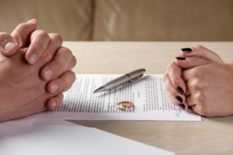 couple sitting in front of divorce paper